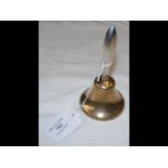 A silver handled call bell
