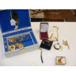A jewellery box containing various costume jewelle