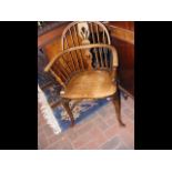 An antique stick back armchair with crinoline stre