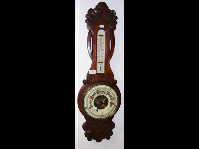 An antique wall barometer/thermometer