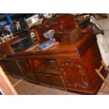 A Victorian mahogany sideboard with shaped back an