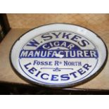 A vintage enameled circular tray inscribed W Sykes