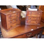 A pair of lockable four drawer collector's cabinet