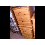 A pair of pine three drawer bedside cabinets