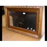 A gilt framed wall mirror