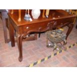 A Victorian mahogany hall table with shaped apron