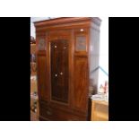 A late Victorian walnut wardrobe with single mirro