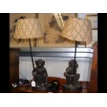 A pair of resin bronze style 'monkey' table lamps