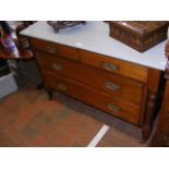 An antique chest of drawers with shabby chic top