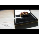 An 18ct gold diamond and garnet ring