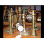 A selection of brass candlesticks, table lamps