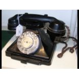 A vintage black metal cradle telephone