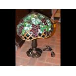 A Tiffany style table lamp with coloured glass mus