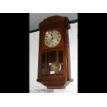 A 1920's oak cased wall clock with three train mov