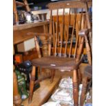 A Windsor stick back arm chair, missing one stretc