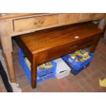 A hardwood coffee table with single drawer under -