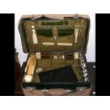 An antique travelling vanity case, with fitted bru