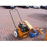A petrol driven turf slitter with tools