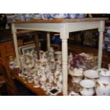 A rustic kitchen table with striped pine top and p