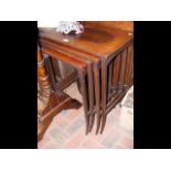 A nest of four mahogany occasional tables