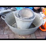 An old galvanised two handled bath, together with