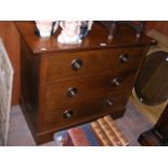 An Arts & Crafts oak chest of three long drawers w