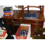 An Edwardian pedestal desk with nine drawers to th