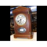 A 1930's French oak cased mantel clock with two tr