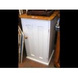 A pine utility cupboard, partially painted off-whi