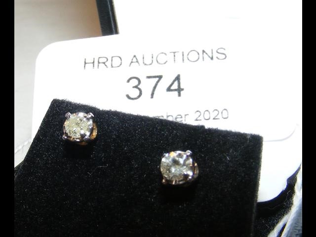 A pair of gold set diamond Solitaire stud earrings