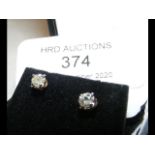 A pair of gold set diamond Solitaire stud earrings