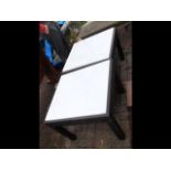 A pair of marble top square garden tables