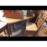 An oak Victorian extending dining table with singl