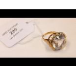 A large silver topaz ring in 18ct gold setting