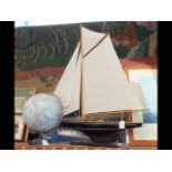 A model gaff rigged yacht together with a reproduc