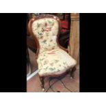 An antique button back easy chair