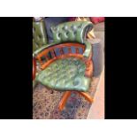 A Victorian style horse shoe swivel armchair uphol