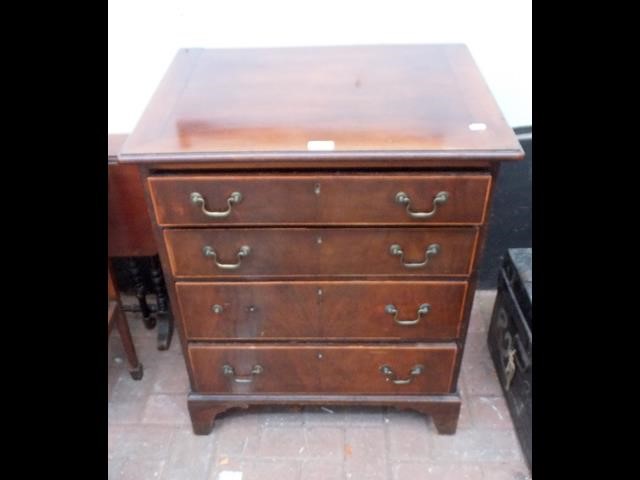 An antique mahogany chest of four graduated drawer