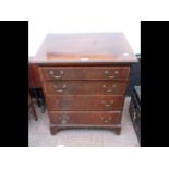 An antique mahogany chest of four graduated drawer