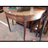 A fold-over 19th century games table on reeded sup
