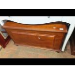 A hardwood blanket chest with raised panel to fron