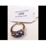 A lady's purple stone dress ring in 9ct gold setti