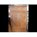 A large pine triple wardrobe with blanket compartm