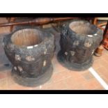 A pair of carved wooden planters, each with four m