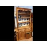 A pine dresser, rack to back, drawers and cupboard