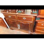 A reproduction hardwood side cabinet with rising t