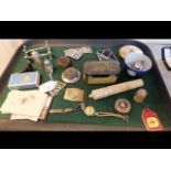 A tray of collectable oddities including silver tr