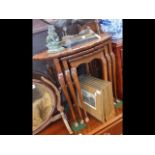 A nest of pie-crust walnut occasional tables