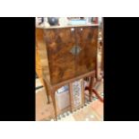 A mid-twentieth century walnut cocktail cabinet en