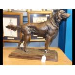 A bronzed resin figure of a hunting dog